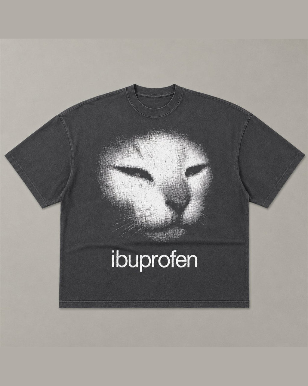 Washed black heavyweight tee with a large faded cat face and the word ibuprofen printed below it