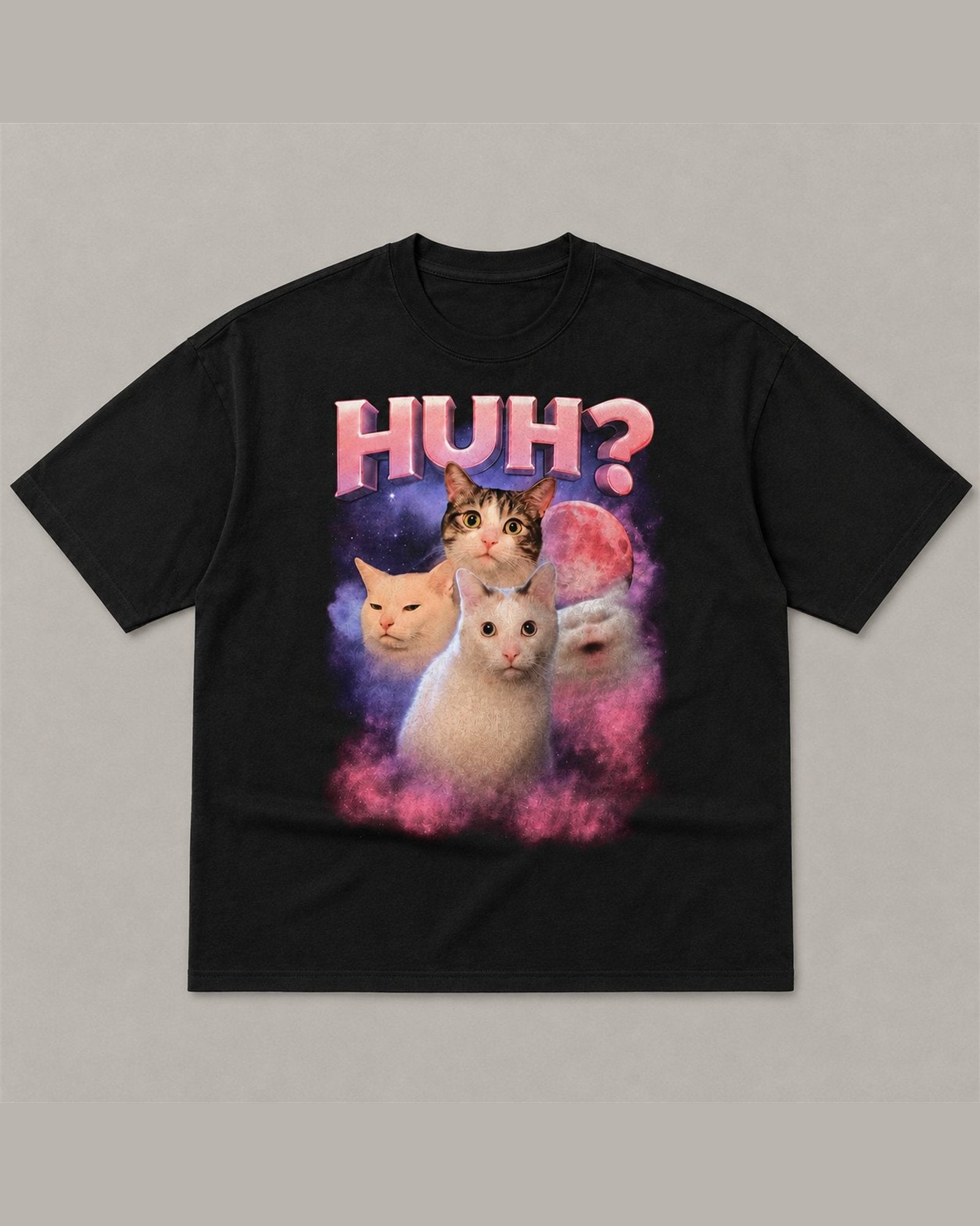 Black heavyweight tee reading HUH? in pink chrome lettering above four cats in a pink and purple space nebula