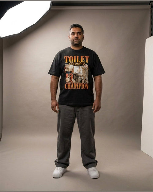 Man wearing the TOILET CLOGGING CHAMPION heavyweight boxy tee in Black