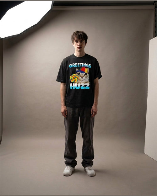 Man wearing the GREETINGS HUZZ heavyweight boxy tee in Black
