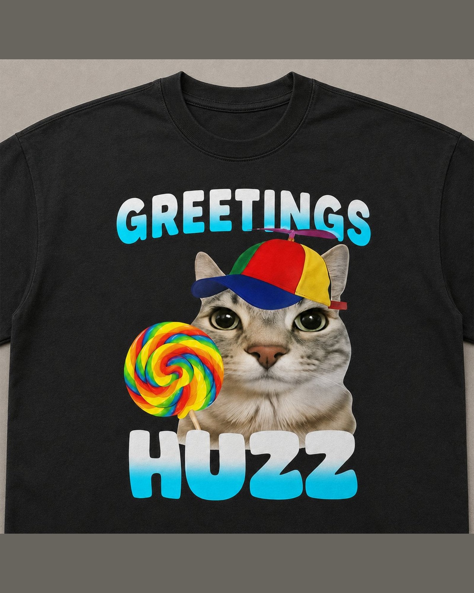 Close-up of the screen printed GREETINGS HUZZ graphic on heavyweight cotton