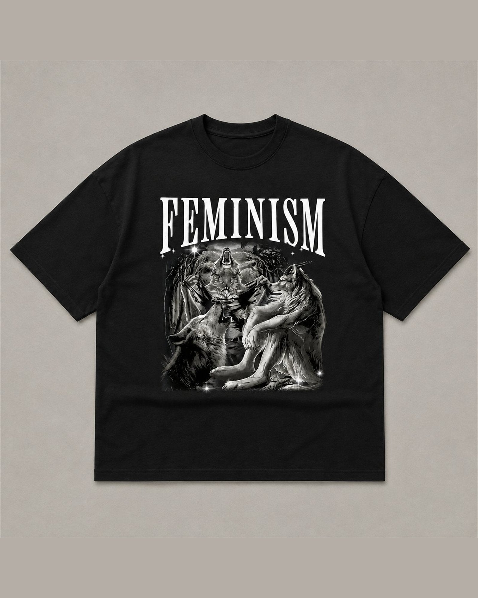 Black heavyweight tee reading FEMINISM in white serif type above a black and white airbrush illustration of howling wolves