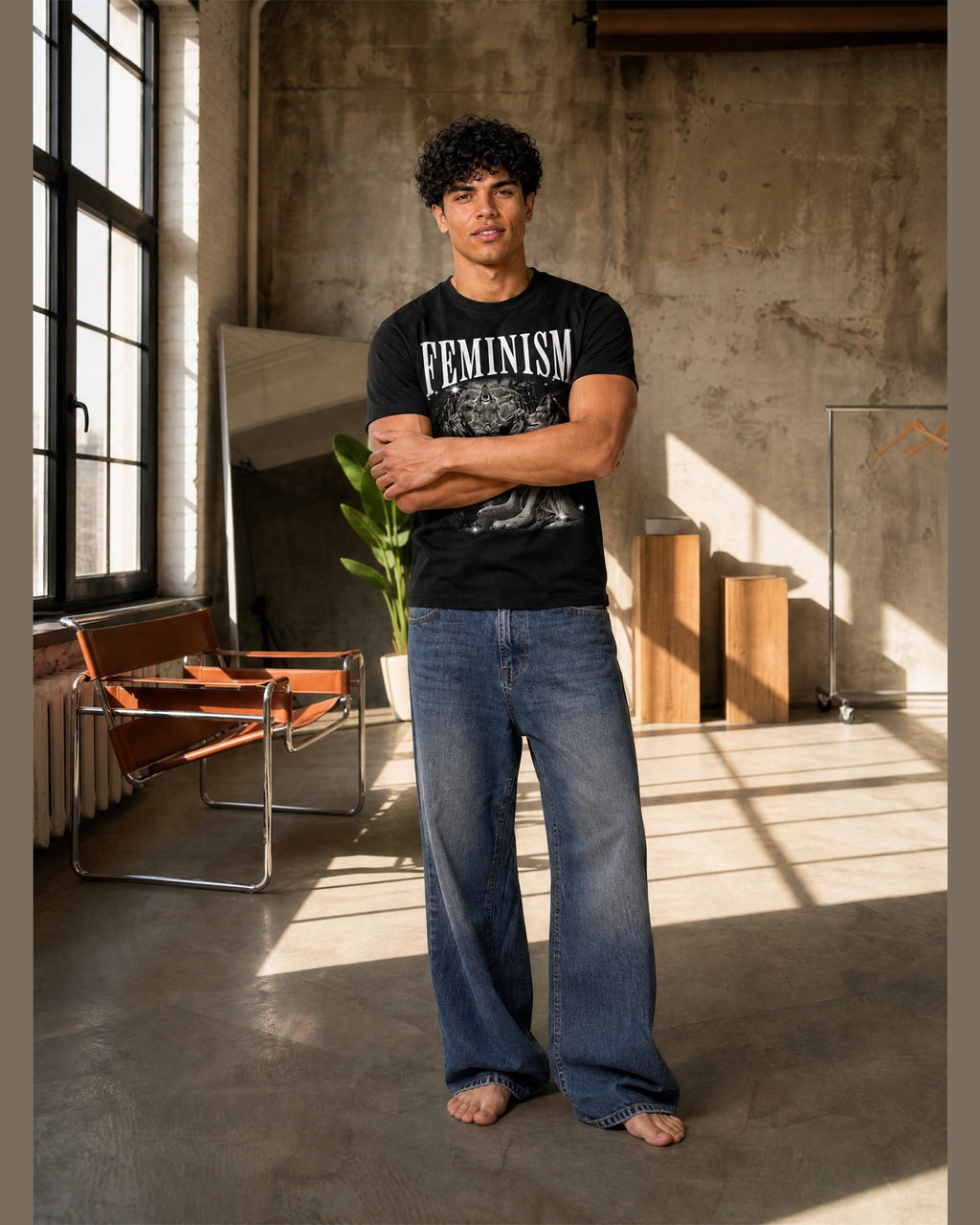 Man wearing the FEMINISM heavyweight boxy tee in Black