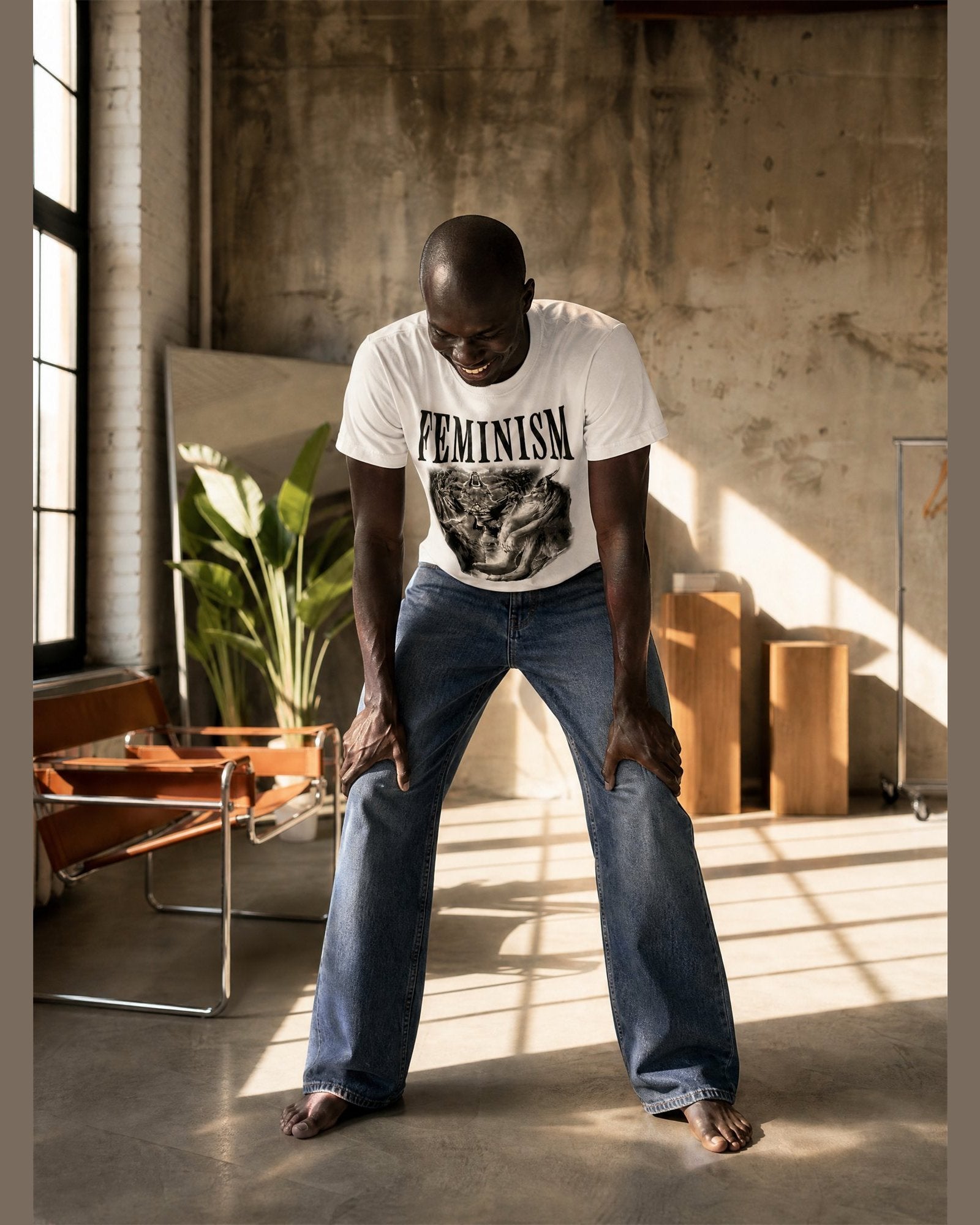 Man wearing the FEMINISM heavyweight boxy tee in White
