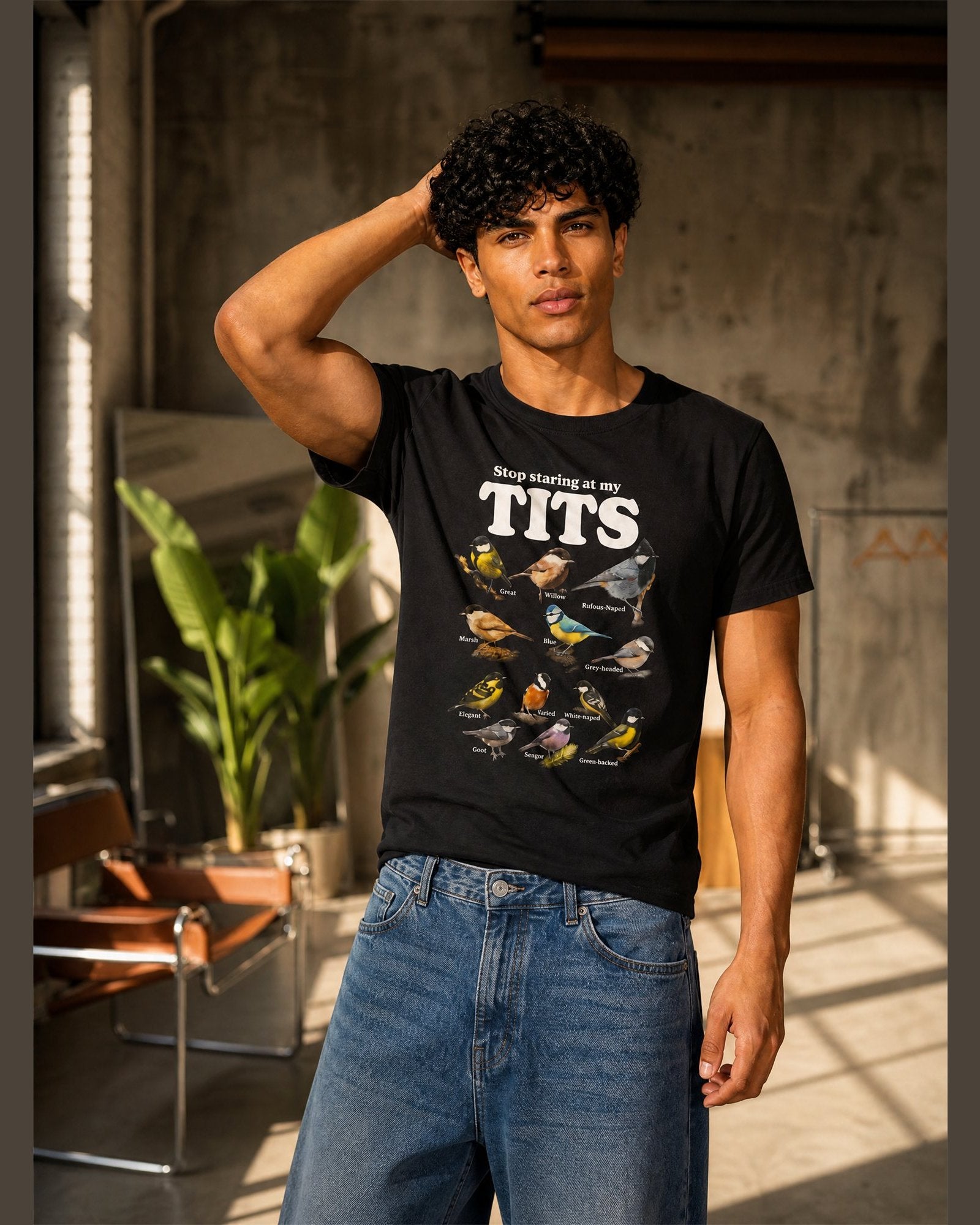 Man wearing the STOP STARING AT MY TITS heavyweight boxy tee in Black