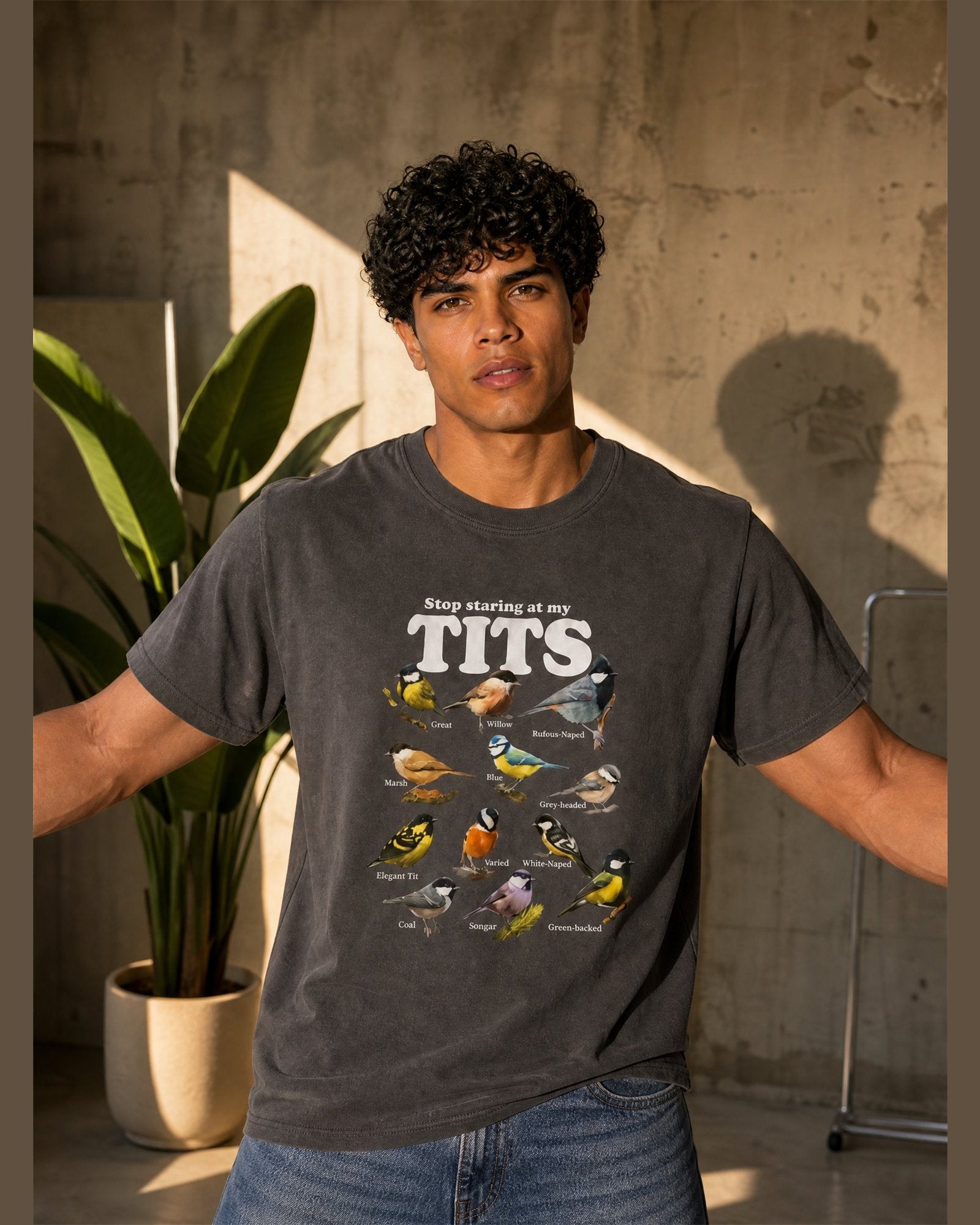 Man wearing the STOP STARING AT MY TITS heavyweight boxy tee in Charcoal