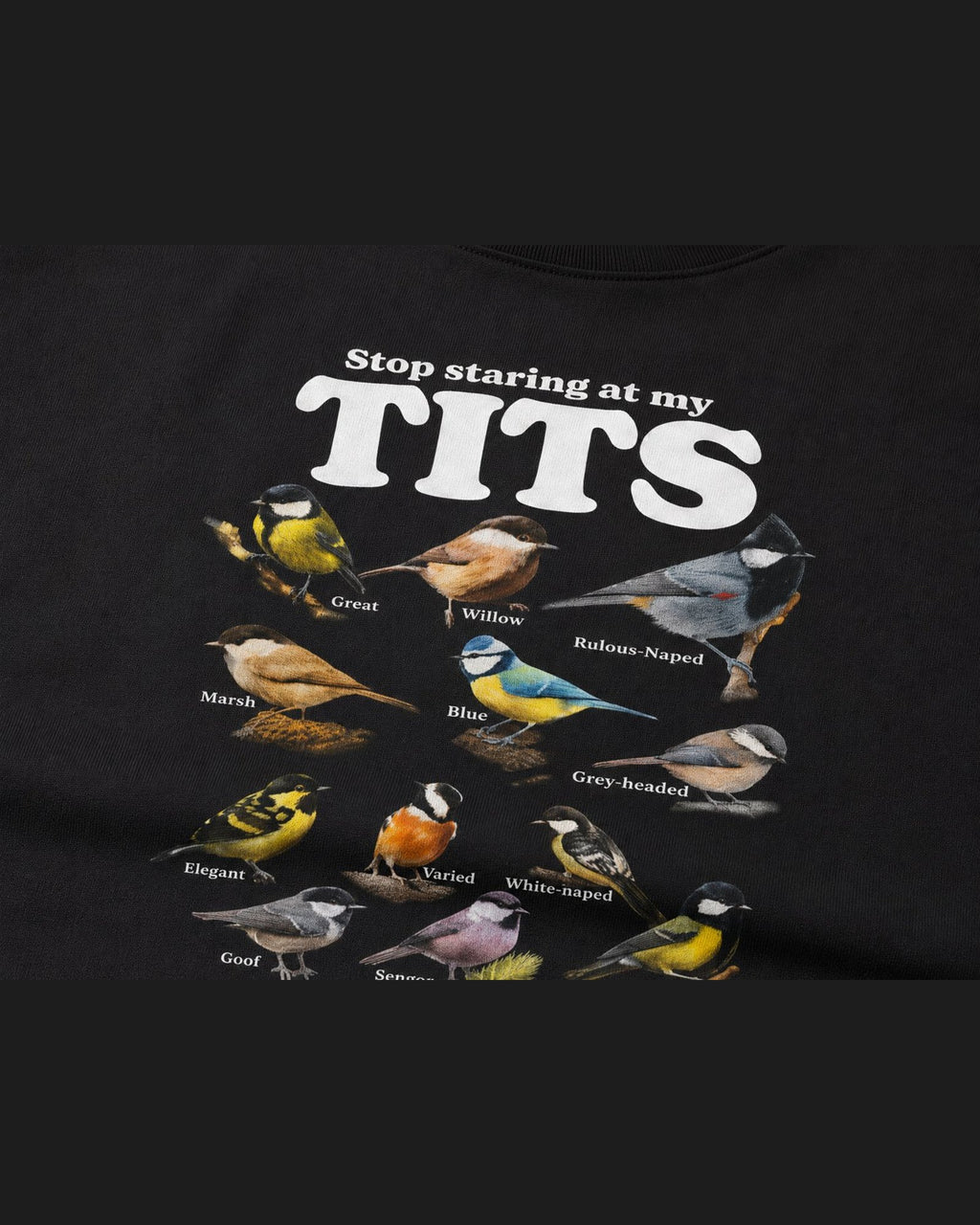 Close-up of the screen printed STOP STARING AT MY TITS graphic on heavyweight cotton