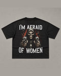 Black heavyweight tee reading I'M AFRAID OF WOMEN above and below an airbrushed hooded skeleton figure